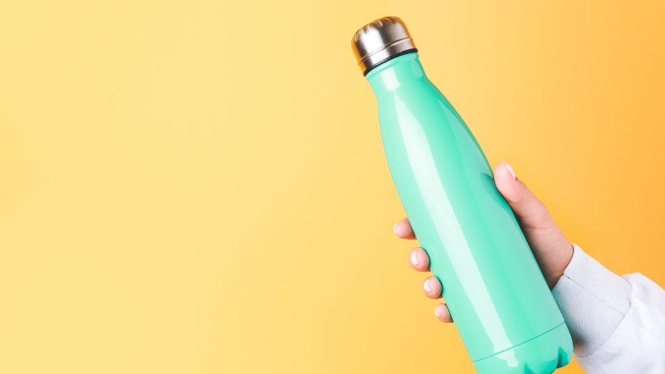 Blue water bottle on yellow background