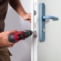 Locksmith drilling on door lock