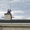 A chimney sweep cleans a home chimney.