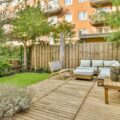 A backyard wooden deck with furniture.