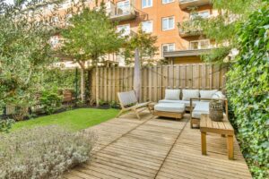 A backyard wooden deck with furniture.