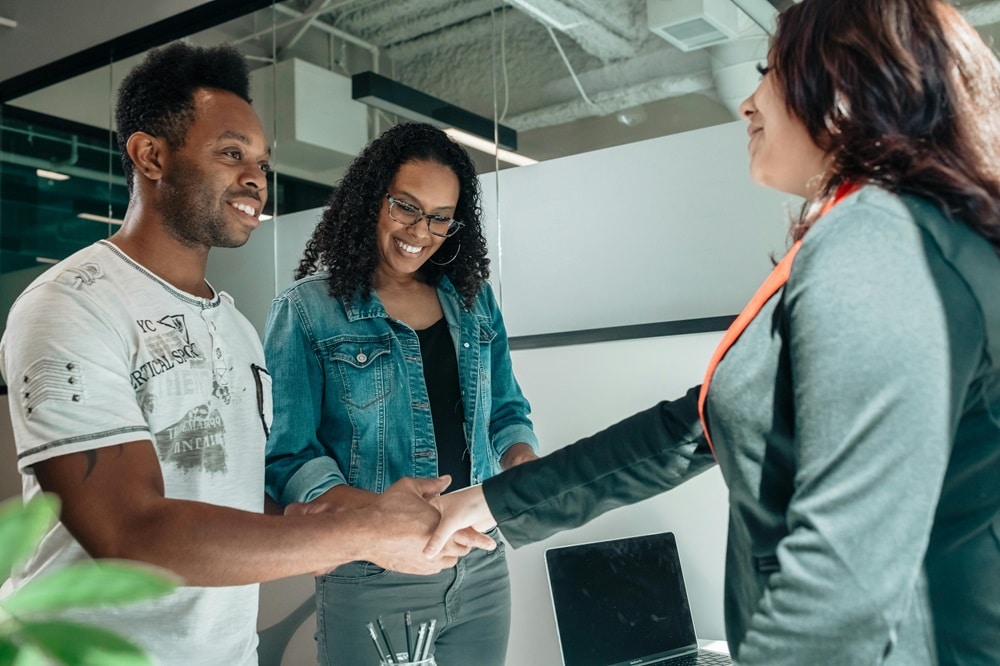 A patent attorney shakes hands with a client.