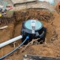 A septic tank being installed in the ground.