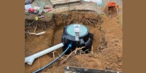 A septic tank being installed in the ground.