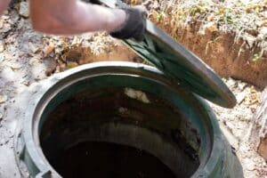 man opening drainage grate