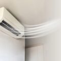 A high-wall heat pump blowing warm air, representing units eligible for the Warmer Kiwi Homes Grant in Palmerston North and throughout New Zealand.