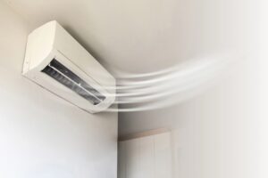 A high-wall heat pump blowing warm air, representing units eligible for the Warmer Kiwi Homes Grant in Palmerston North and throughout New Zealand.