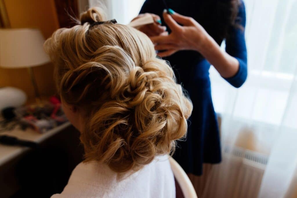 hairdresser styling bridal hair